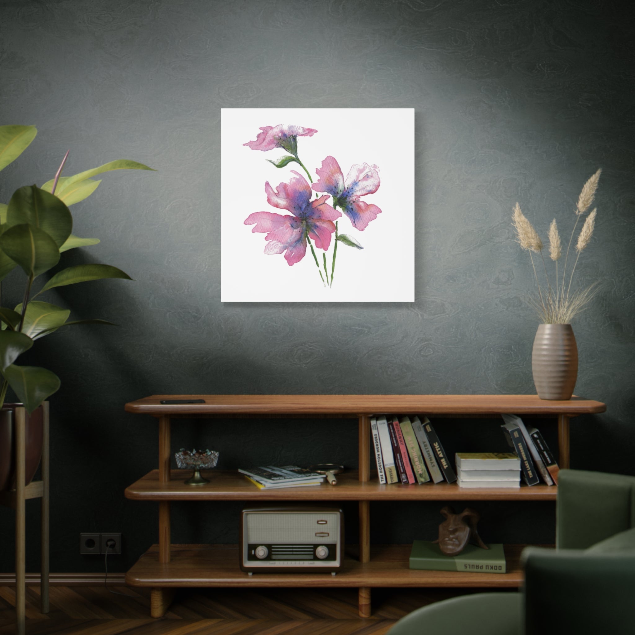 Floral artwork on a wall above a wooden shelf with books and decor.