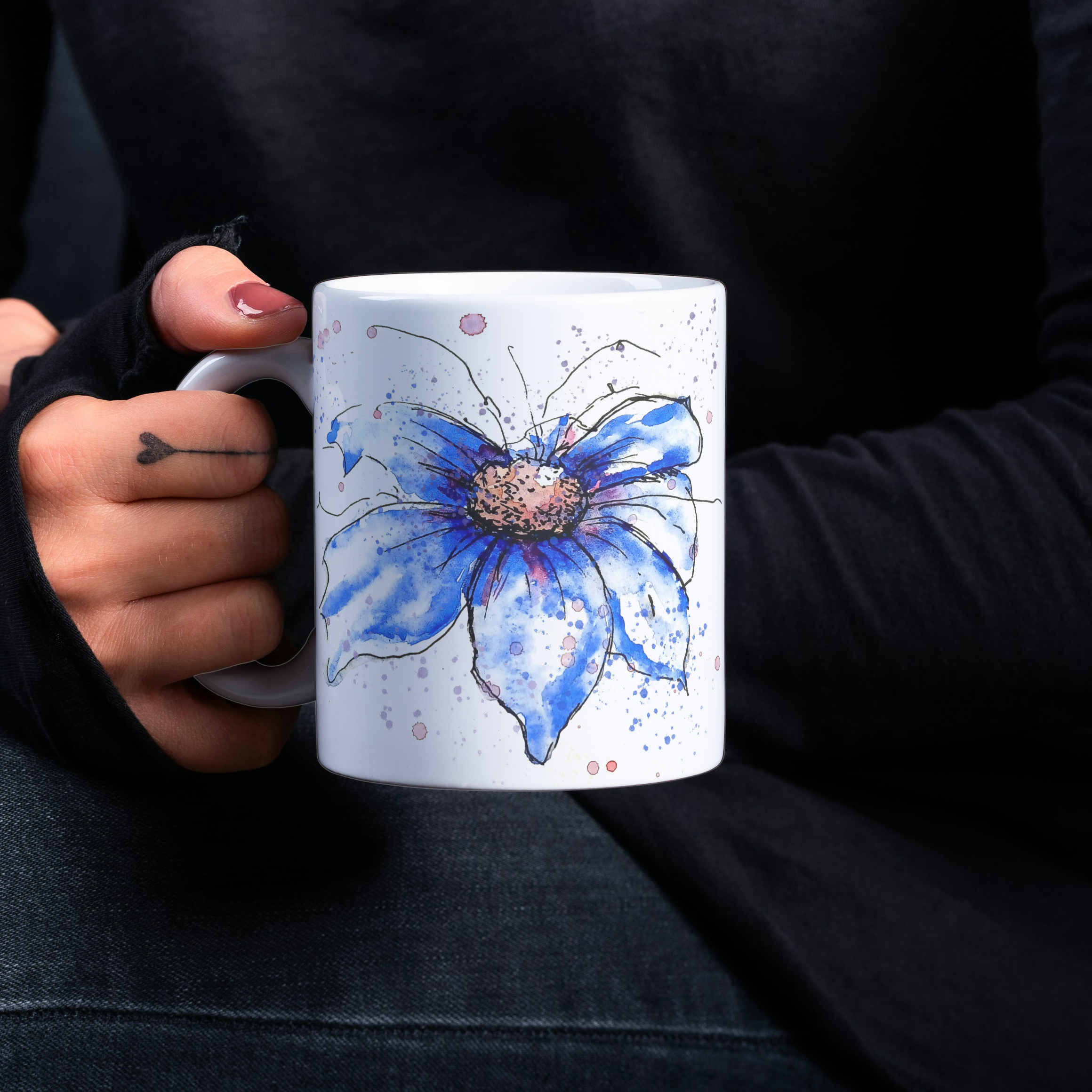  Blue cosmos ceramic mug held in hand against black background showing artwork detail and C-handle