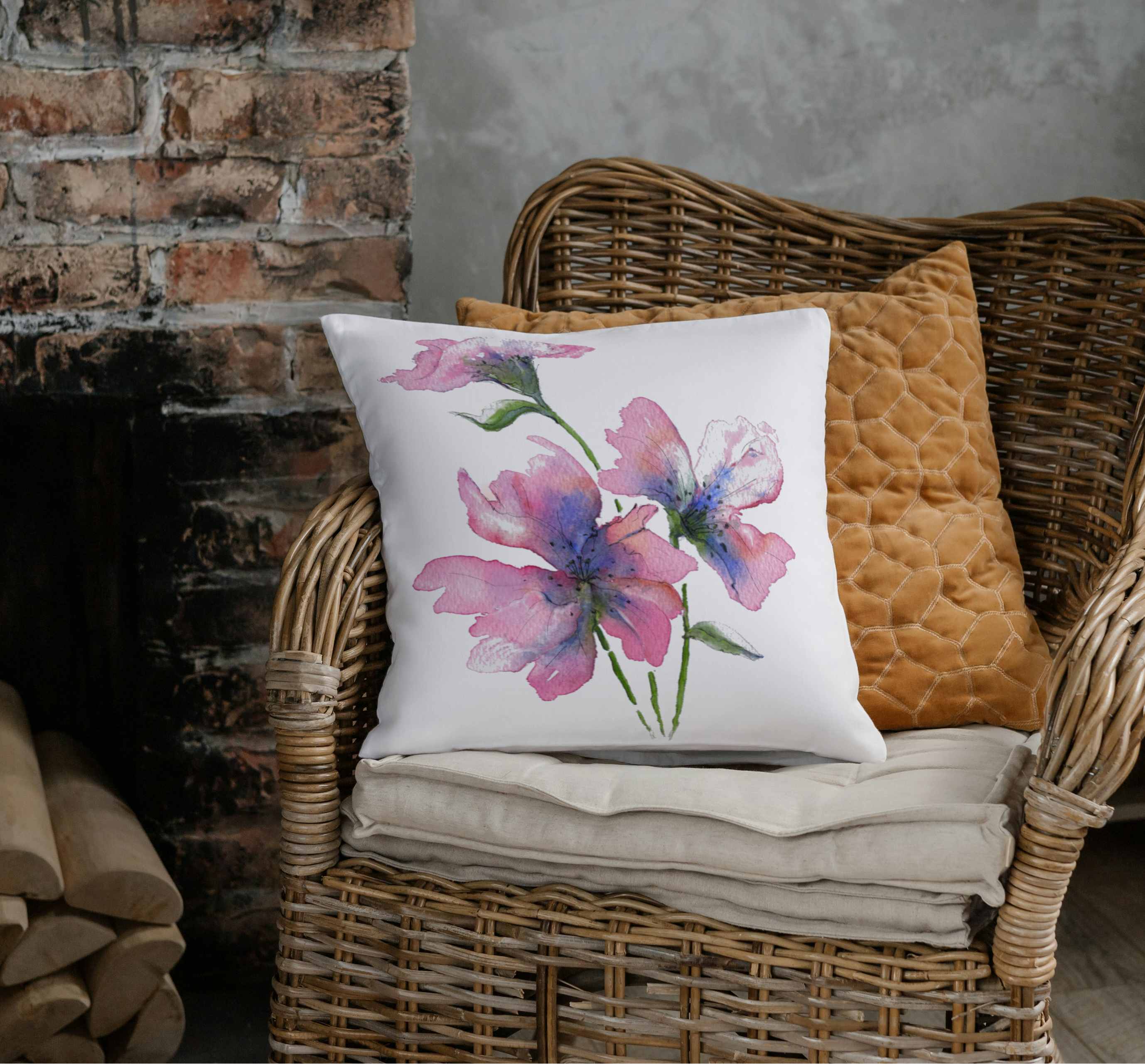 Pink flower linen cushion on a wicker chair, next to a brick fireplace