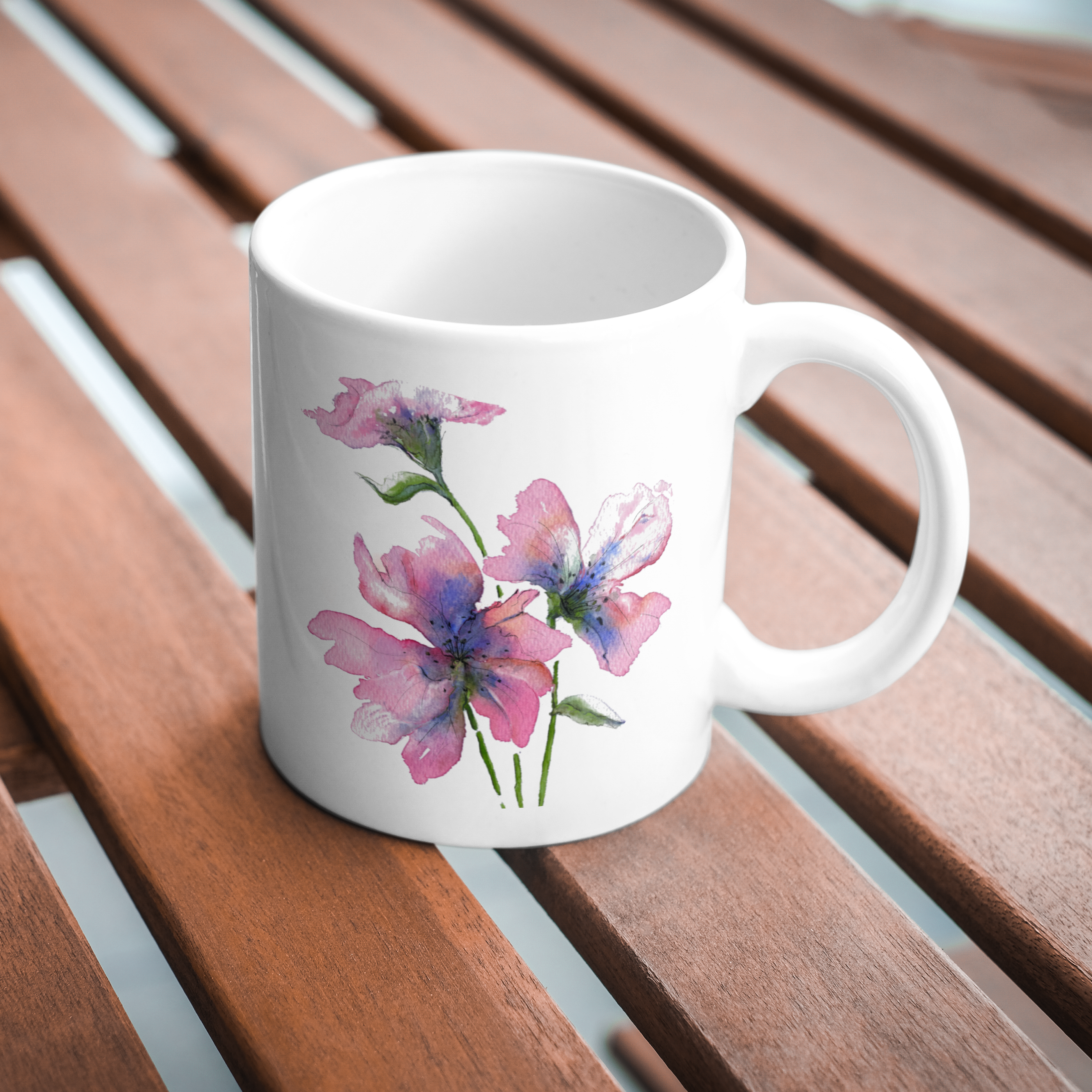 White mug with floral design on a wooden surface